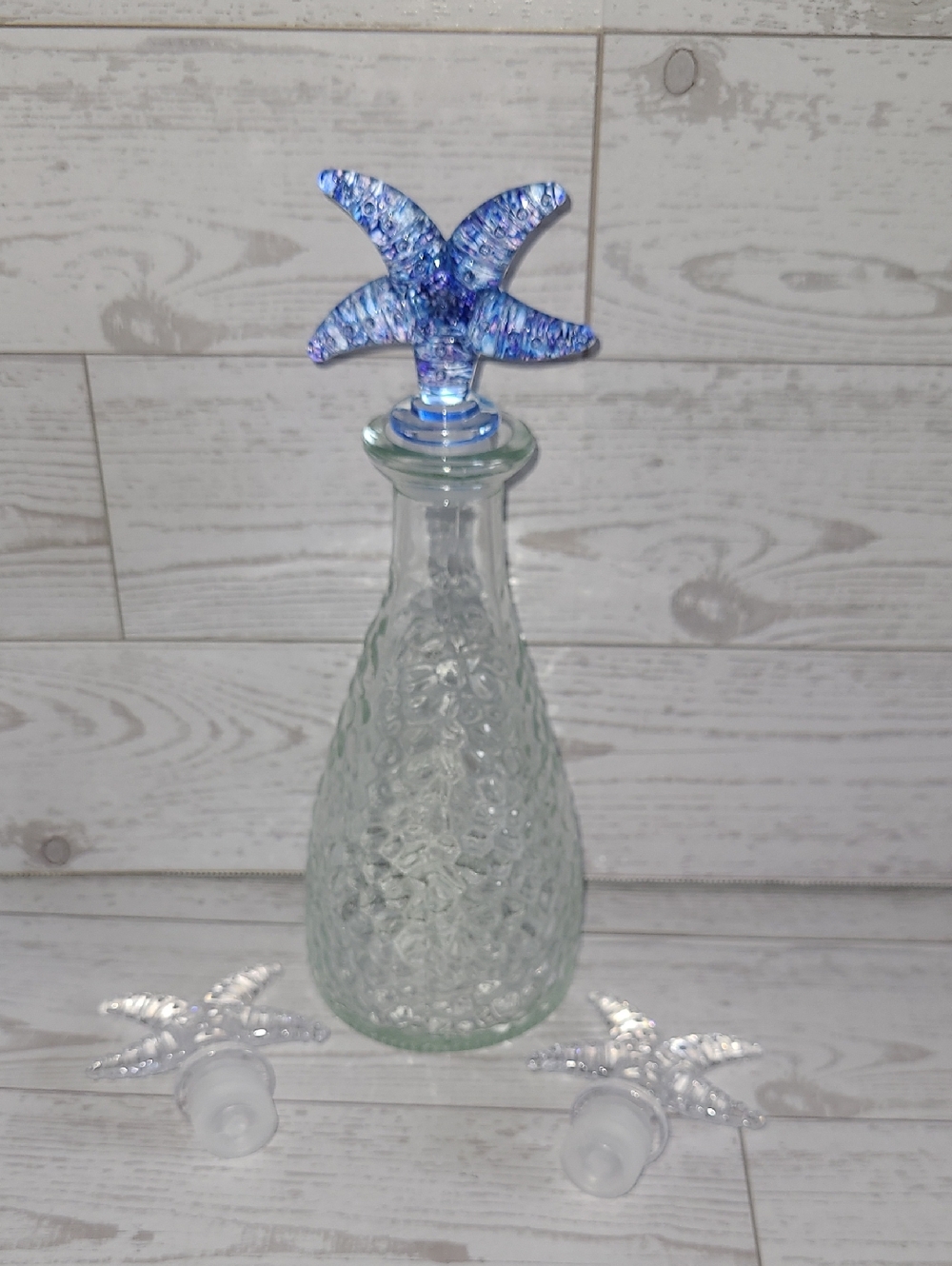 Glass Bottle With Blue Starfish Plastic Stopper And Two Clear Stoppers